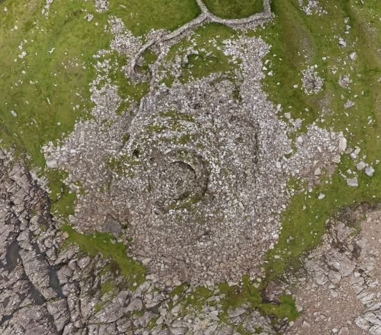 Look closely at this jumble of stone and the concentric circles of a broch outer wall and inserted wheel house will reveal themselves. This is Levenwick Broch in Shetland. Photo by Eddie Martin.